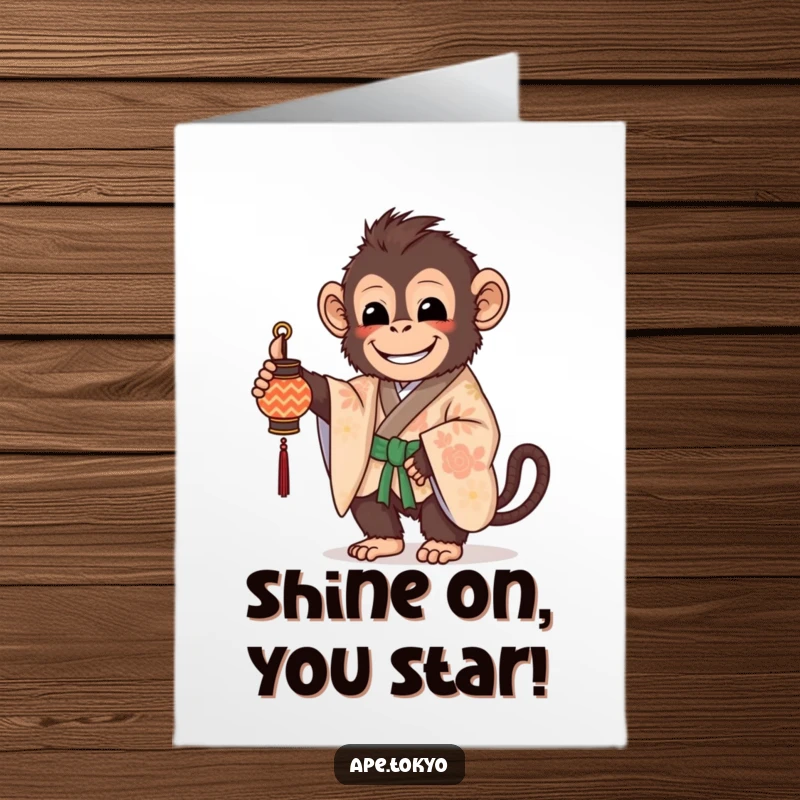 Free Printable Congrats Card: A beaming ape in a beautifully patterned kimono holds a small, decorated lantern, signifying celebration.