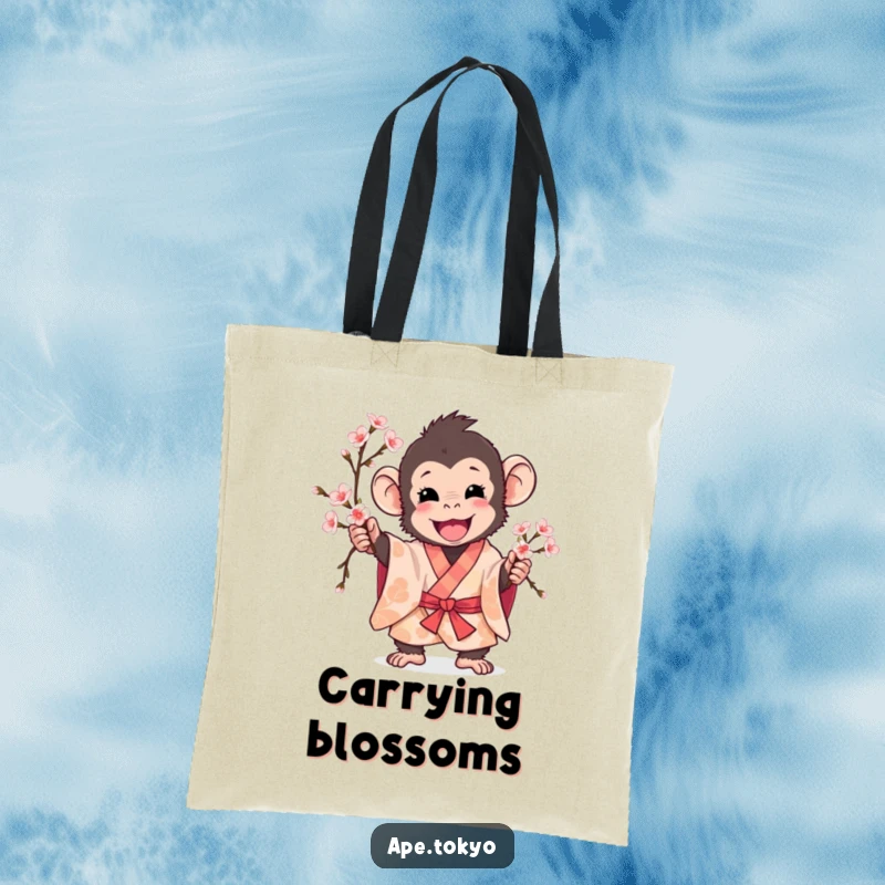 Funny ape in patterned kimono excitedly holding a cherry blossom branch, tote bag, spring accessory.